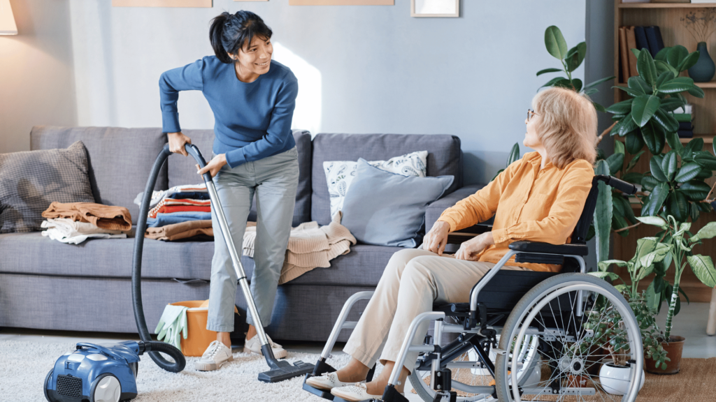 A staff member cleaning for an assisted living client.